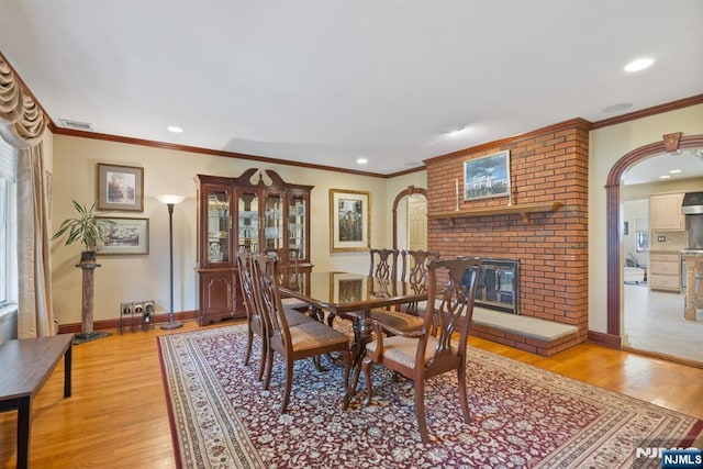 dining space with recessed lighting, baseboards, light wood-type flooring, and ornamental molding