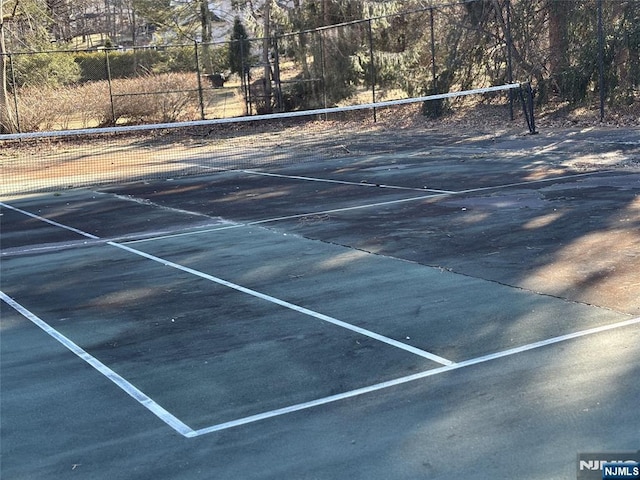 view of tennis court with fence