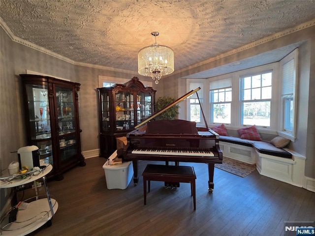 living area featuring baseboards, a notable chandelier, ornamental molding, and dark wood-style flooring