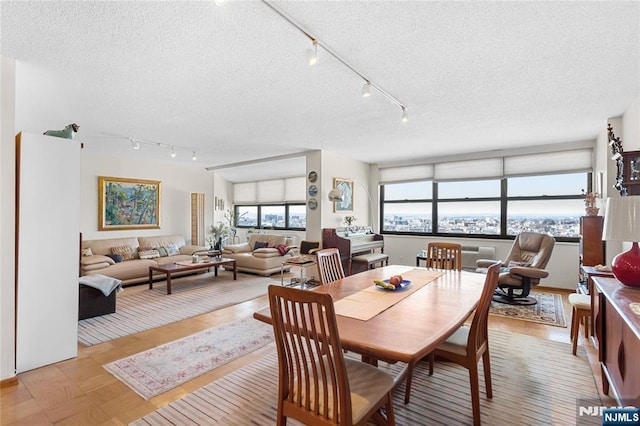 dining space with a textured ceiling