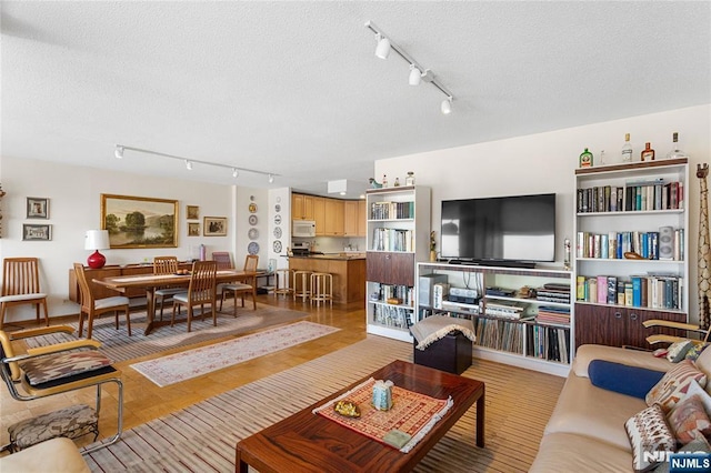 living area with a textured ceiling and wood finished floors