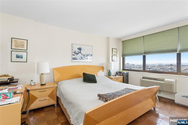 bedroom with radiator and an AC wall unit