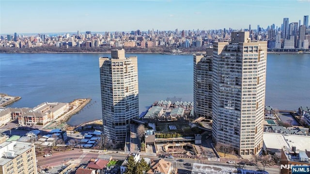 birds eye view of property with a view of city and a water view