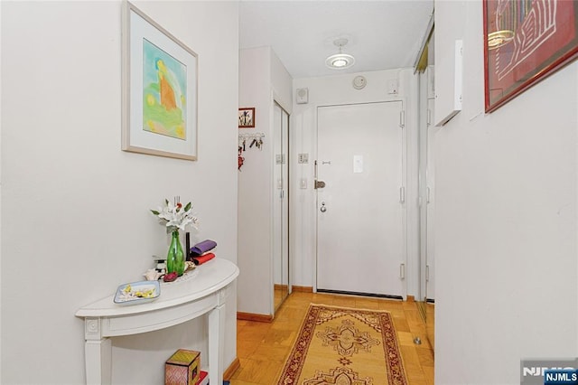 doorway to outside with baseboards