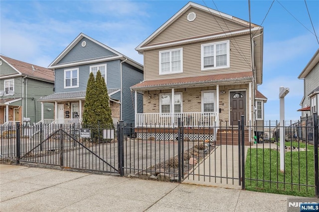 view of front of property featuring a fenced front yard, covered porch, brick siding, and a gate