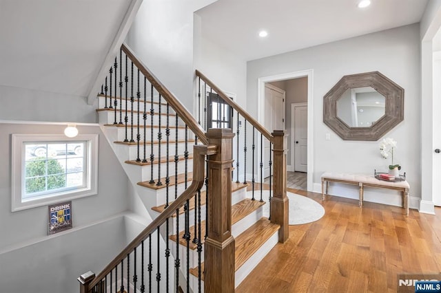 staircase featuring recessed lighting, baseboards, and wood finished floors