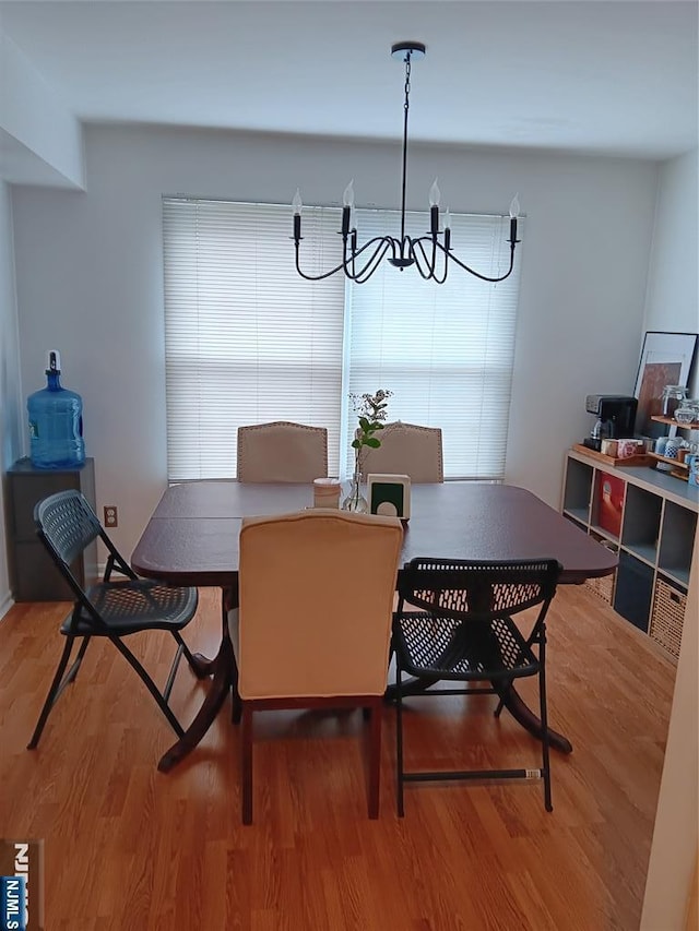 dining area featuring a notable chandelier and wood finished floors