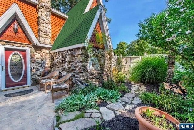 exterior space with a patio, a fireplace, and fence