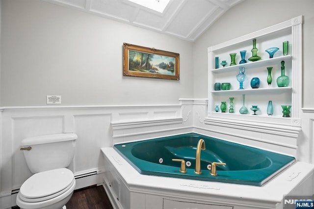 full bathroom featuring toilet, a wainscoted wall, baseboard heating, and a jetted tub