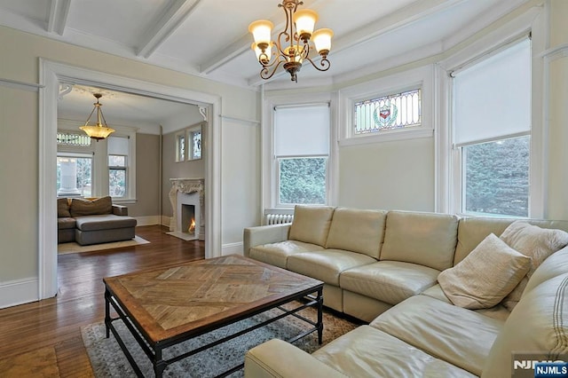 living room with plenty of natural light, dark wood-type flooring, and a high end fireplace