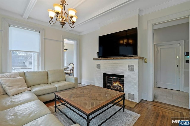 living area featuring a chandelier, a fireplace, wood finished floors, visible vents, and beamed ceiling