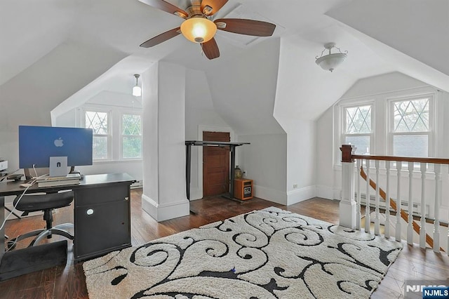 office area featuring vaulted ceiling, plenty of natural light, baseboards, and wood finished floors