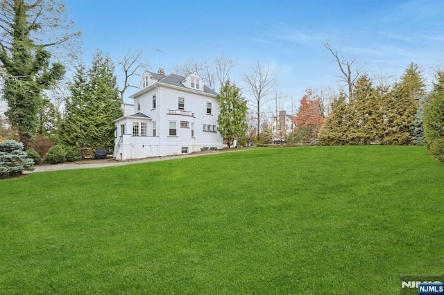 exterior space featuring a chimney and a yard