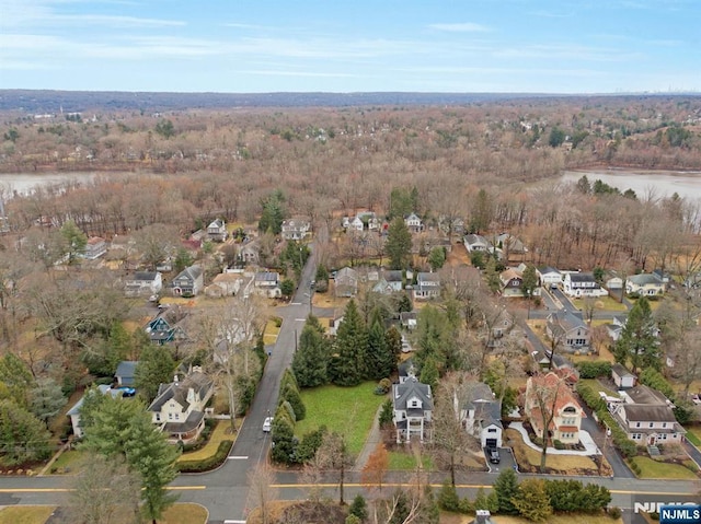 bird's eye view featuring a residential view, a water view, and a forest view