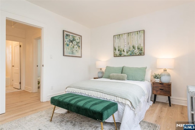 bedroom featuring light wood-style flooring and baseboards