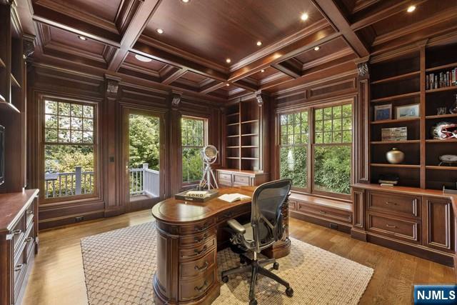 office area with wooden ceiling, wooden walls, and coffered ceiling