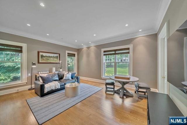 interior space featuring recessed lighting, crown molding, baseboards, and wood finished floors