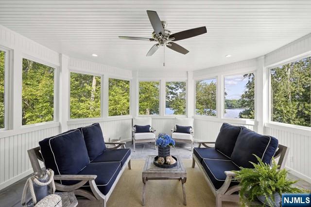 sunroom with ceiling fan and a wealth of natural light