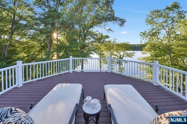 wooden deck featuring a water view