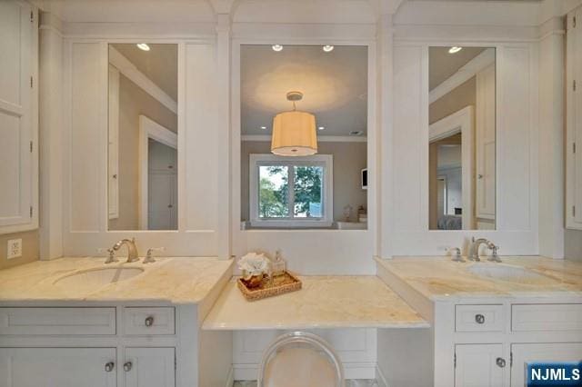 bathroom with ornamental molding and vanity