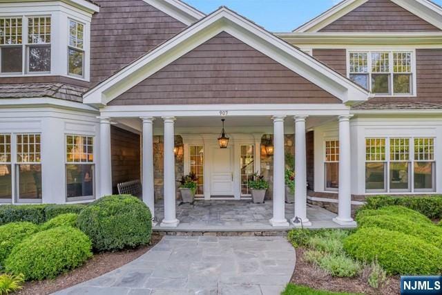 view of exterior entry featuring a porch