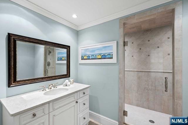 full bath with recessed lighting, vanity, baseboards, a stall shower, and crown molding