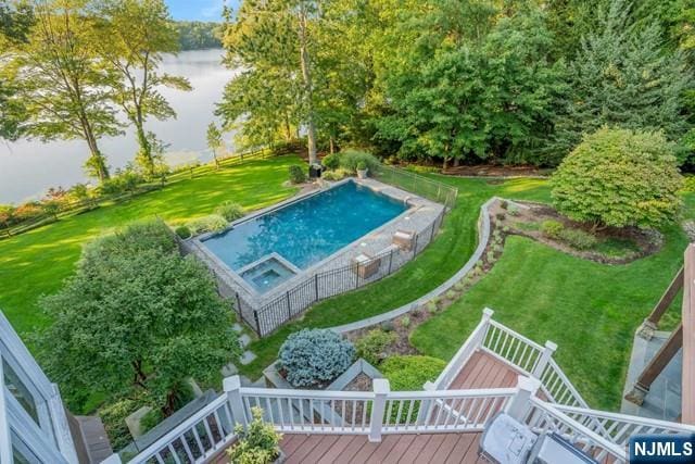 view of swimming pool with a fenced in pool, a lawn, and a deck with water view