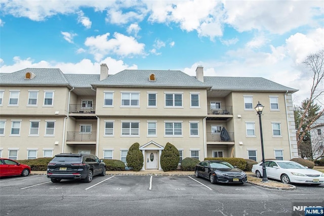 view of building exterior featuring uncovered parking