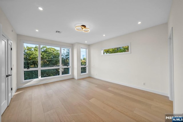 spare room with baseboards, recessed lighting, visible vents, and light wood-style floors