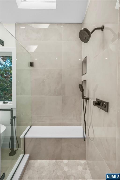 full bathroom with a tile shower