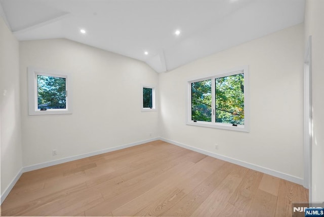 unfurnished room featuring lofted ceiling, baseboards, light wood finished floors, and recessed lighting