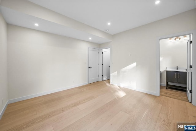 spare room with recessed lighting, light wood-style flooring, and baseboards