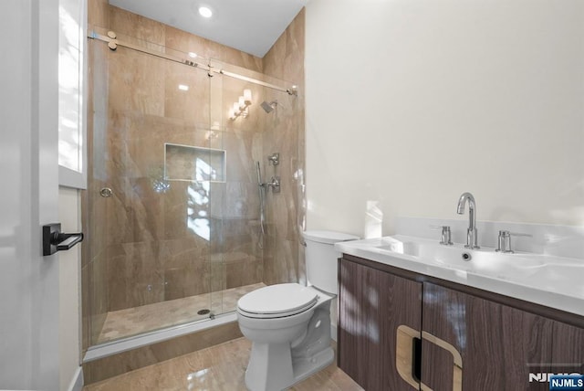 full bath featuring a shower stall, toilet, and vanity