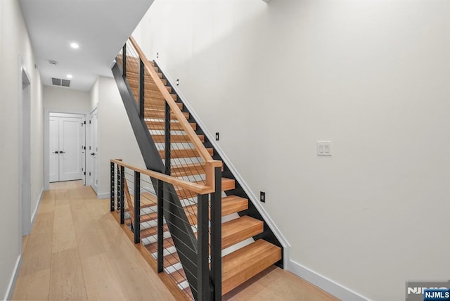 stairs featuring recessed lighting, wood finished floors, visible vents, and baseboards