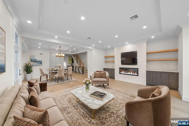 living room with light wood-style flooring, recessed lighting, a large fireplace, visible vents, and stairs