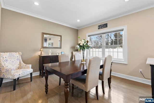 dining space featuring ornamental molding, recessed lighting, baseboards, and wood finished floors