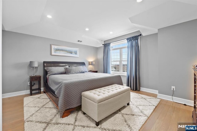 bedroom featuring visible vents, baseboards, wood finished floors, and recessed lighting