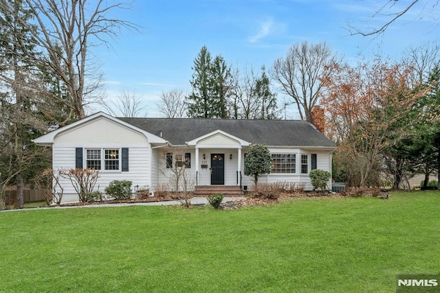 single story home featuring a chimney and a front lawn