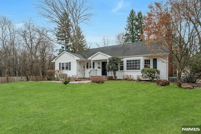 ranch-style home featuring fence and a front yard