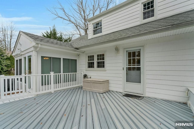 wooden deck featuring a sunroom