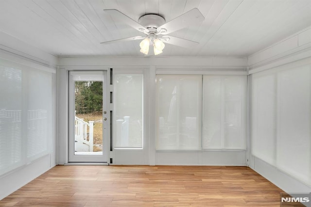 unfurnished sunroom with wooden ceiling and ceiling fan