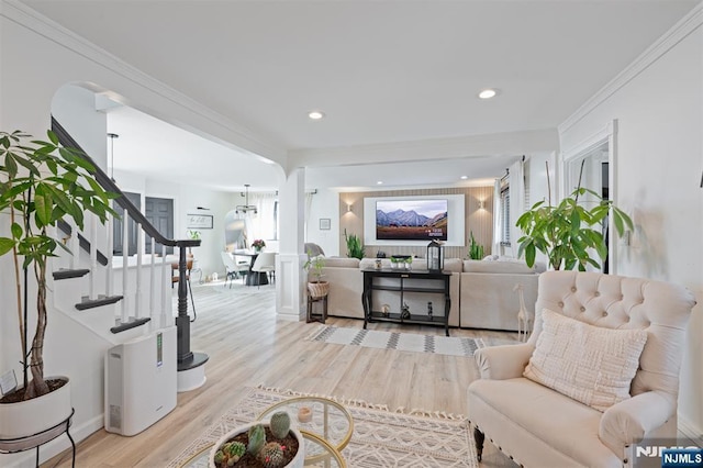 living room with light wood-type flooring, stairway, ornamental molding, and recessed lighting