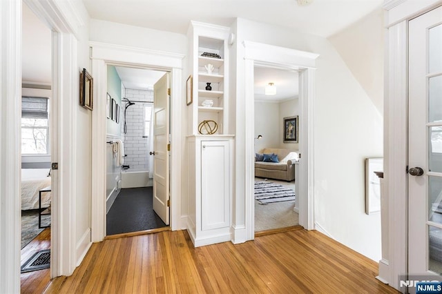 corridor featuring light wood finished floors and visible vents