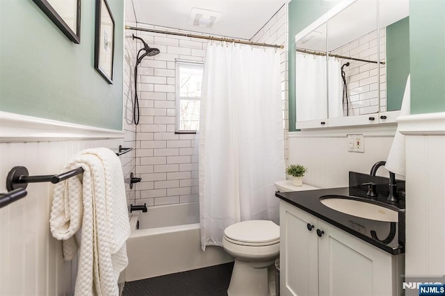 full bath with toilet, a wainscoted wall, vanity, visible vents, and shower / bath combination with curtain