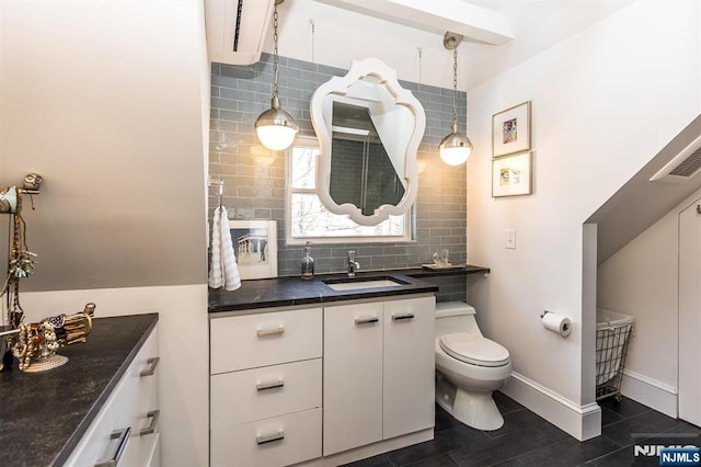 bathroom with toilet, baseboards, decorative backsplash, and vanity