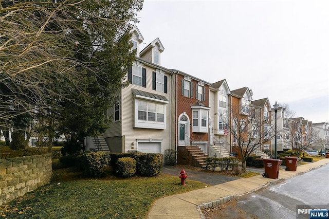 townhome / multi-family property with an attached garage and a residential view