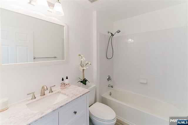 full bath featuring washtub / shower combination, visible vents, vanity, and toilet