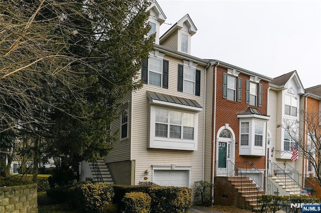 multi unit property with brick siding and an attached garage