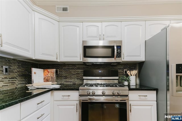 kitchen featuring appliances with stainless steel finishes, white cabinets, and decorative backsplash