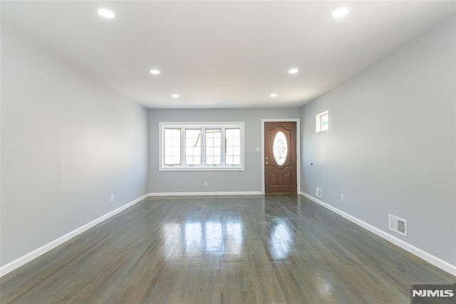 foyer entrance with dark wood-type flooring, recessed lighting, visible vents, and baseboards